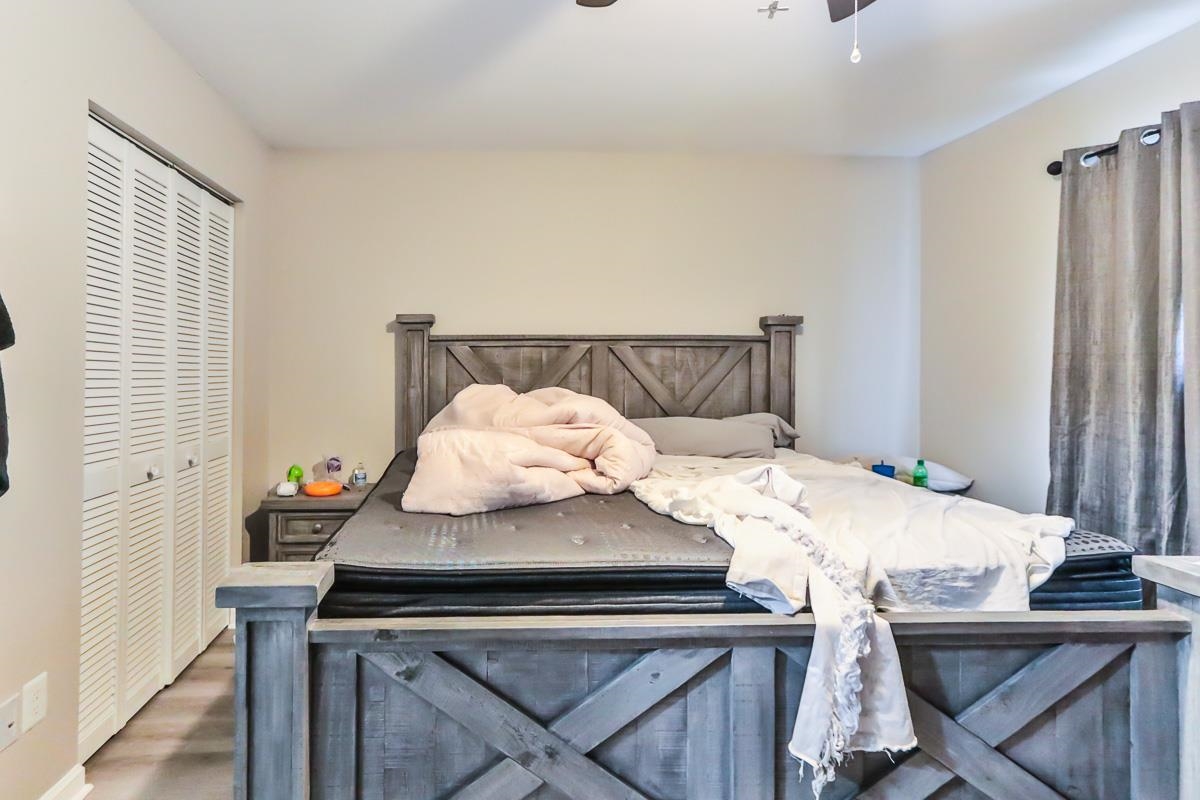 205 Plantation Road Myrtle Beach, SC 29588 - Photo 23 of 35 Bedroom featuring ceiling fan, a closet, and hardw