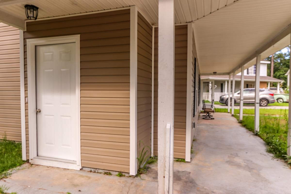 205 Plantation Road Myrtle Beach, SC 29588 - Photo 29 of 35 View of exterior entry with a carport