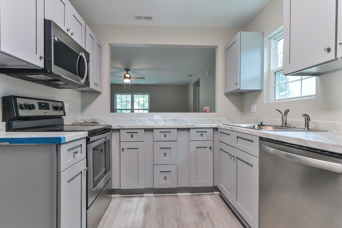 205 Plantation Road Myrtle Beach, SC 29588 - Photo 6 of 35 Kitchen with ceiling fan, stainless steel applianc