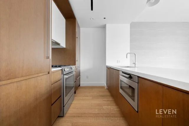 a view of kitchen with granite countertop cabinets and a sink
