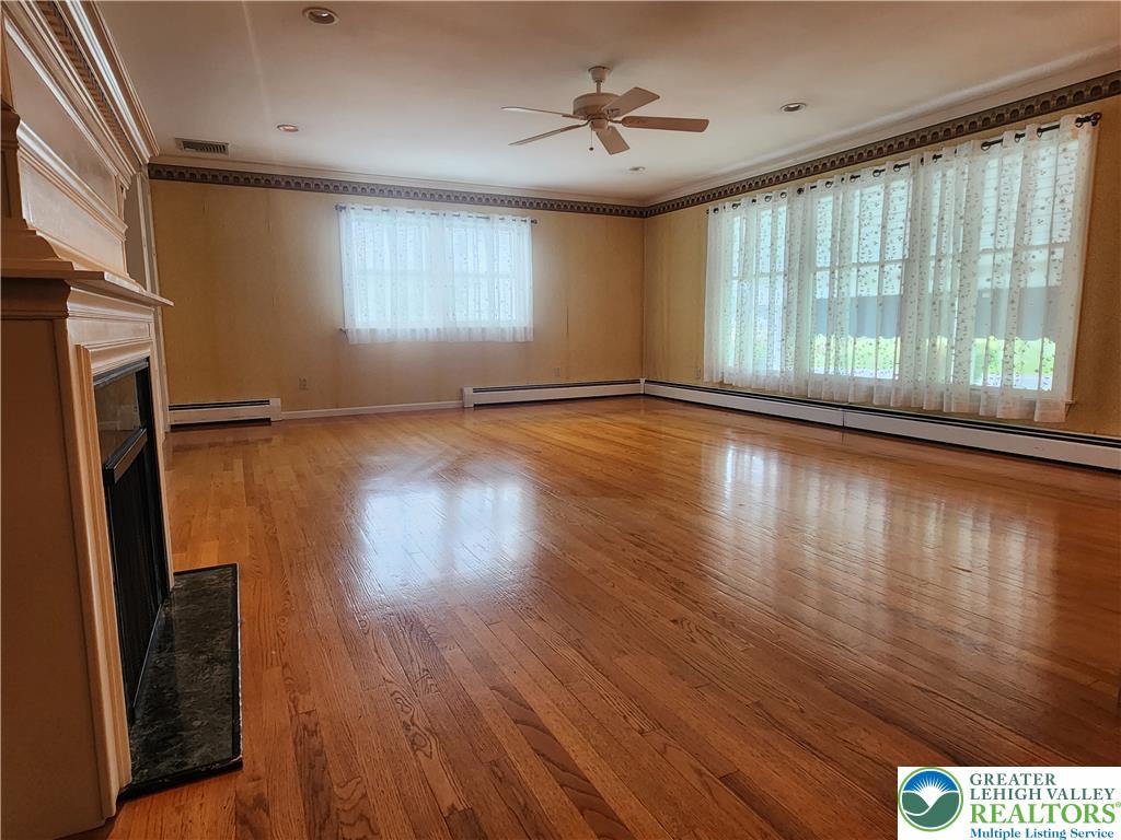 1480 Teels Road Pen Argyl, PA 18072 - Photo 9 of 18 Gleaming hardwood floors and a classic fireplace define this versatile living space.
