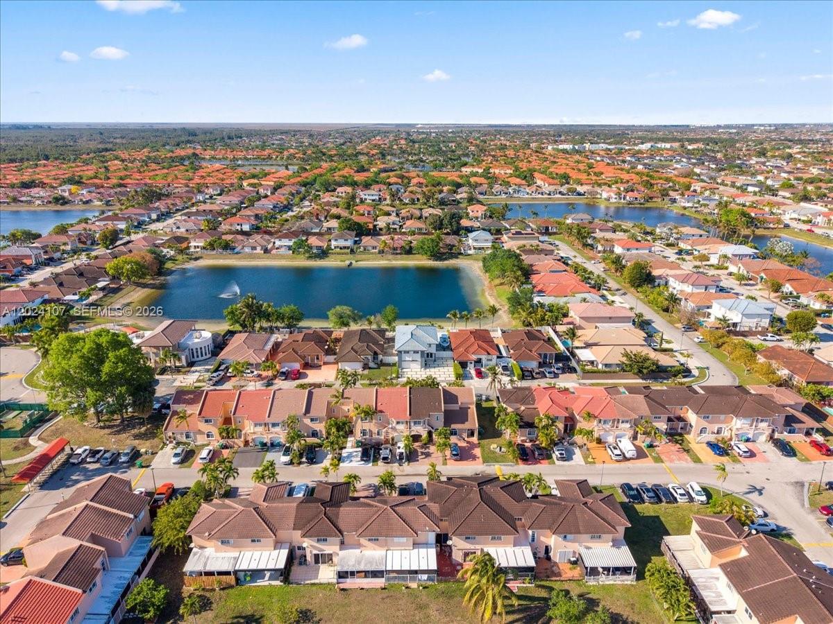 15341 Southwest 36th Street Miami, FL 33185 - Photo 50 of 56 an aerial view of a city with lots of residential buildings ocean and mountain view in back