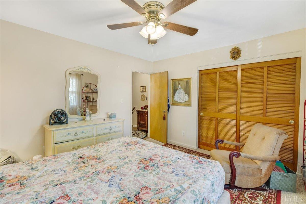 3101 Link Road, Unit 89 Lynchburg, VA 24503 - Photo 13 of 23 a bedroom with a bed and a chandelier