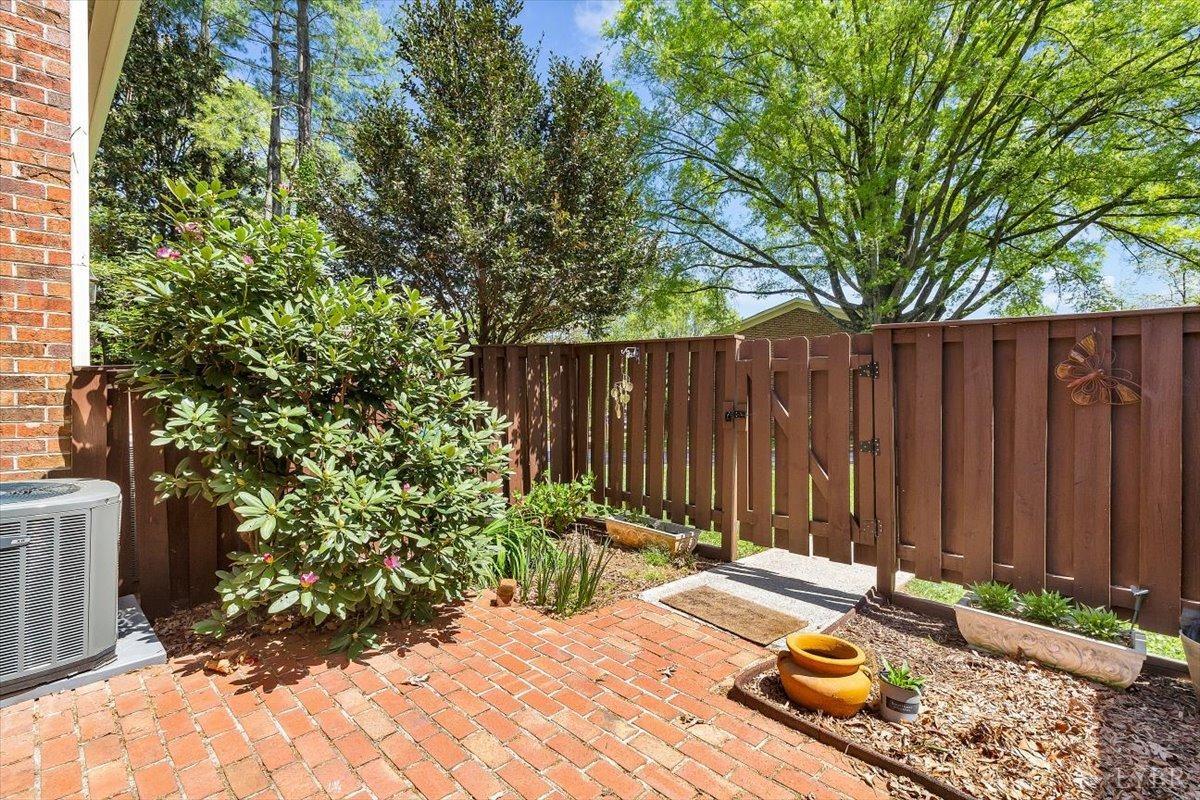 3101 Link Road, Unit 89 Lynchburg, VA 24503 - Photo 19 of 23 a view of a backyard with table and chairs and wooden fence