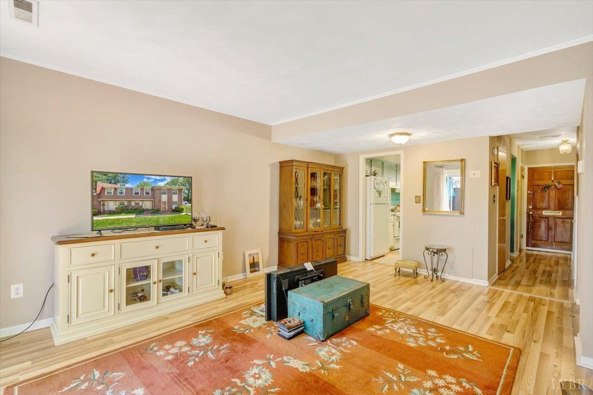 3101 Link Road, Unit 89 Lynchburg, VA 24503 - Photo 4 of 23 a living room with furniture a flat screen tv and a rug