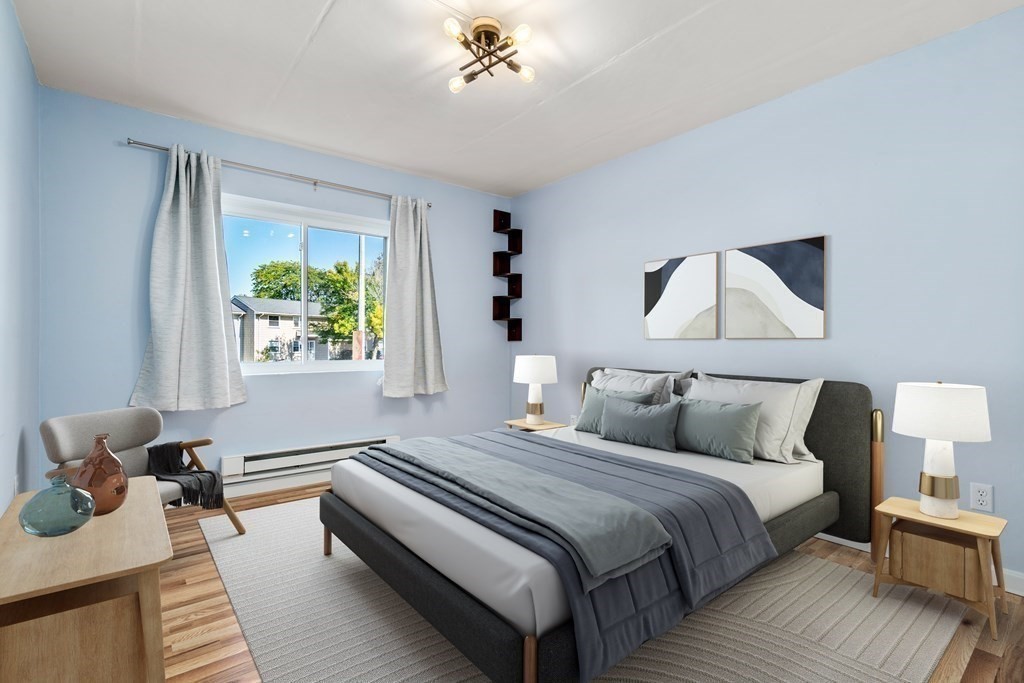 30 High Street, Unit 101 Dedham, MA 02026 - Photo 13 of 36 a bedroom with bed and a window