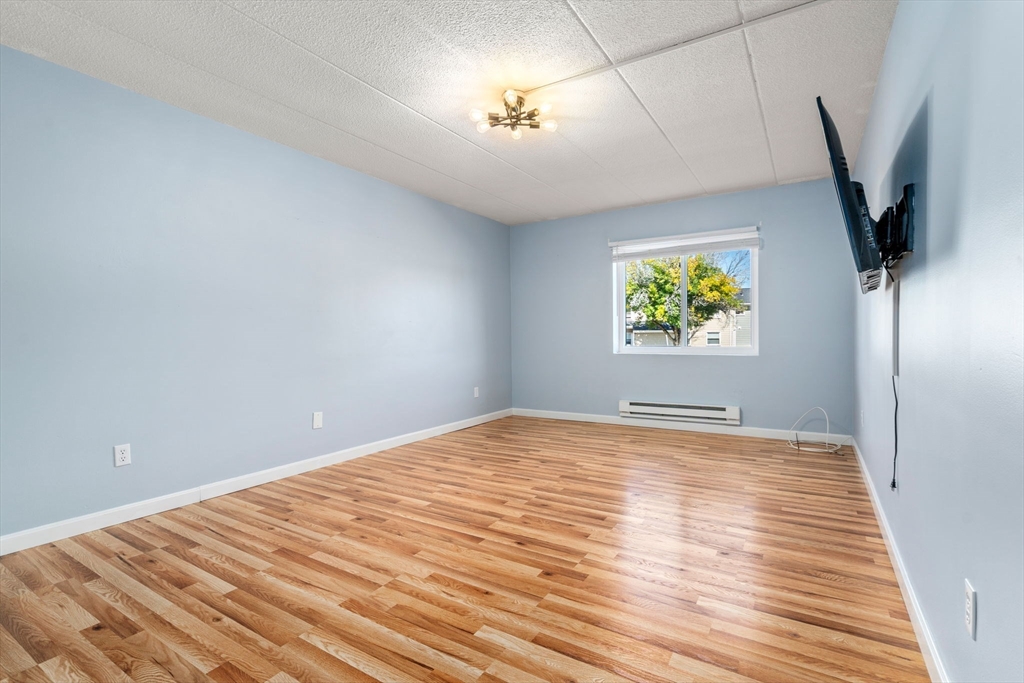 30 High Street, Unit 101 Dedham, MA 02026 - Photo 17 of 36 a view of an empty room and a window