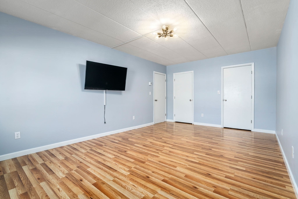 30 High Street, Unit 101 Dedham, MA 02026 - Photo 18 of 36 a view of empty room with a flat screen tv