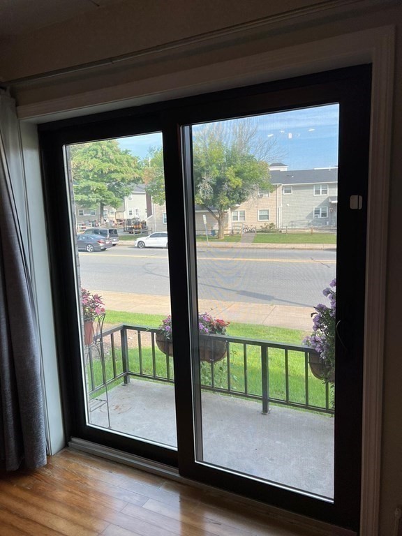 30 High Street, Unit 101 Dedham, MA 02026 - Photo 22 of 36 a view of a room with wooden floor and a porch