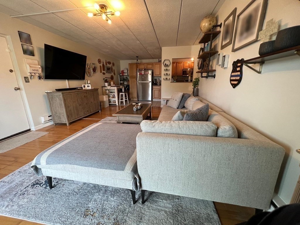 30 High Street, Unit 101 Dedham, MA 02026 - Photo 23 of 36 a living room with furniture and a flat screen tv