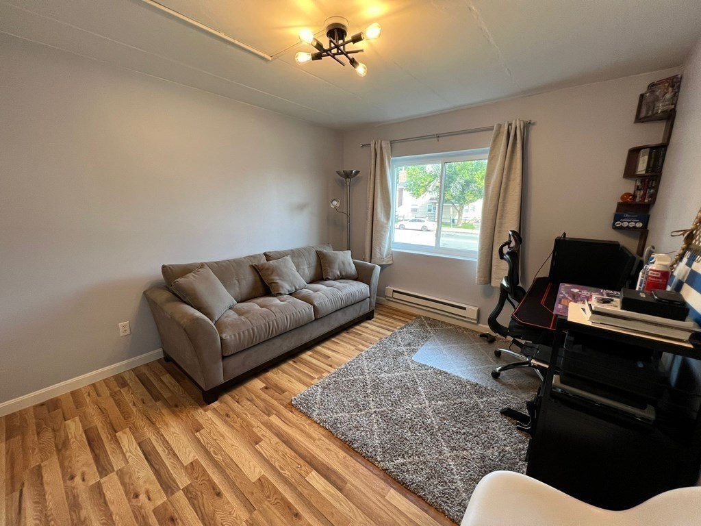 30 High Street, Unit 101 Dedham, MA 02026 - Photo 25 of 36 a living room with furniture rug and window