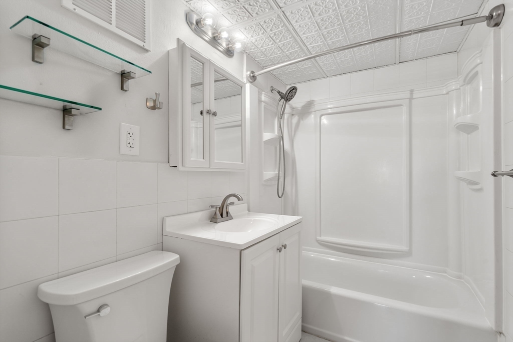 30 High Street, Unit 101 Dedham, MA 02026 - Photo 27 of 36 a bathroom with a sink toilet and shower