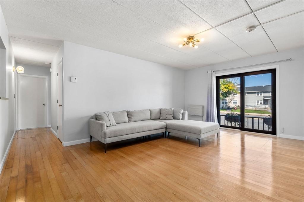 30 High Street, Unit 101 Dedham, MA 02026 - Photo 6 of 36 a living room with furniture and wooden floor