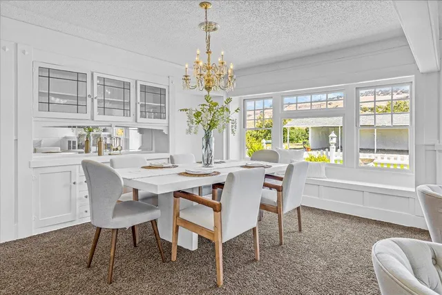 a kitchen with stainless steel appliances granite countertop a sink stove and white cabinets with wooden floor