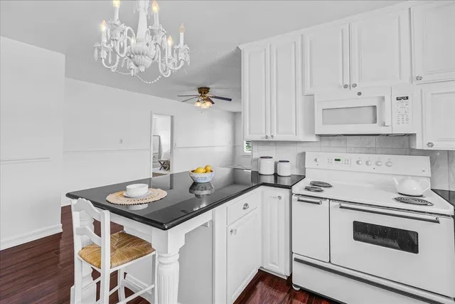 a spacious bedroom with a bed and a chandelier