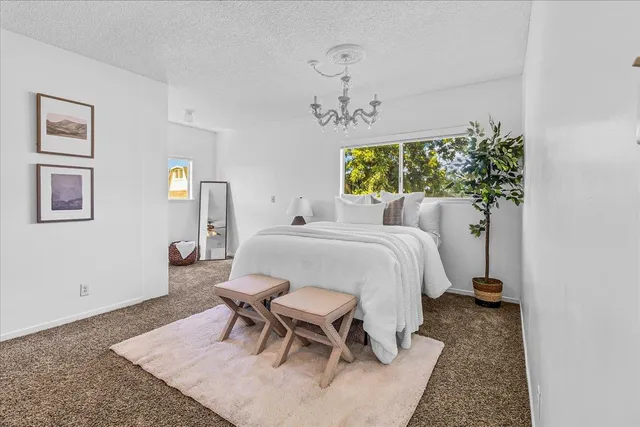 a bathroom with a granite countertop sink a toilet and mirror