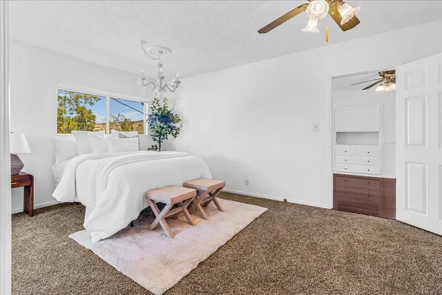 a bedroom with a bed next to a window