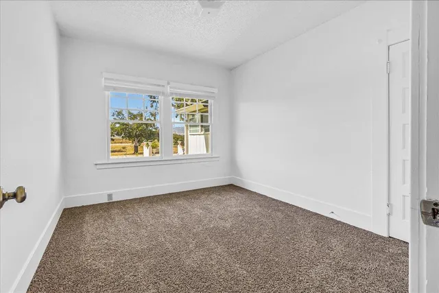 a bathroom with a granite countertop sink a mirror a vanity and a shower