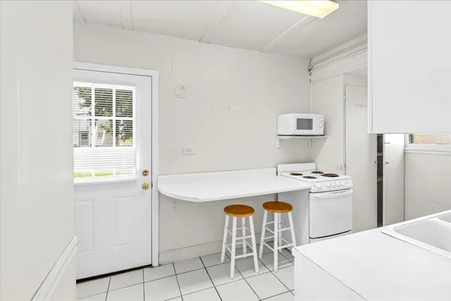 an aerial view of a house with a yard and lake view