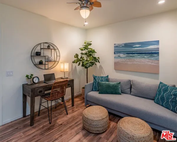 a living room with furniture a chandelier and a window