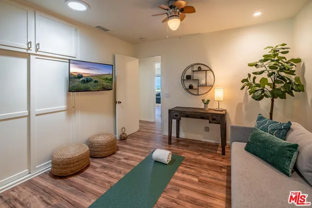 a living room with furniture and a potted plant