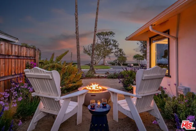a view of a patio with table and chairs potted plants
