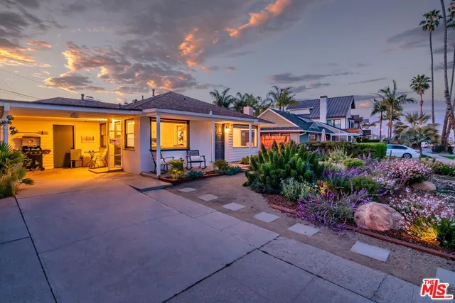 a front view of house with yard and outdoor seating