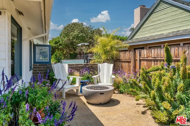 a view of a balcony with chair and potted plants