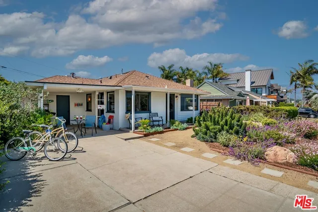 a front view of a house with a garden and porch