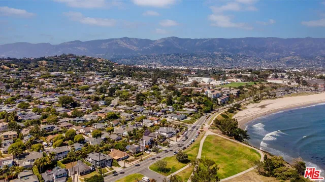 an aerial view of residential house and sandy dunes
