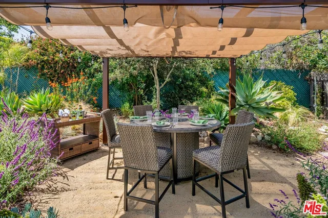 a outdoor dining space with furniture and outdoor view