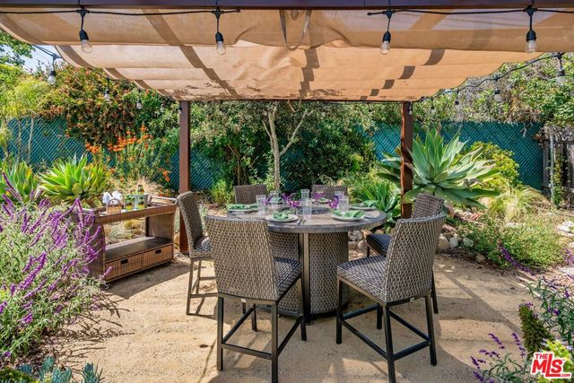 a outdoor dining space with furniture and outdoor view