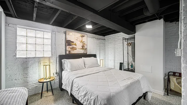 a bedroom with a bed a table and chair