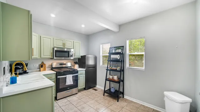 a kitchen with a sink appliances and cabinets
