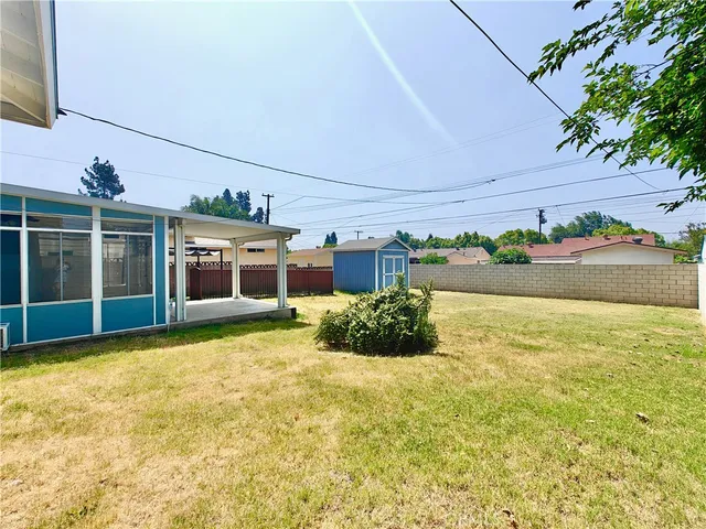 a front view of house with yard and trees in the background