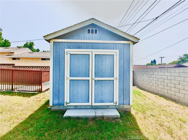 a view of a house with a yard and potted plants