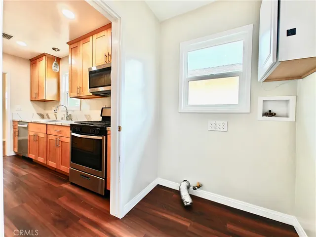 a kitchen with stainless steel appliances a stove a sink and a microwave