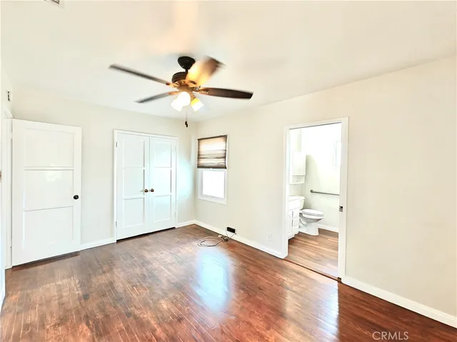 a kitchen with a sink and wooden floor