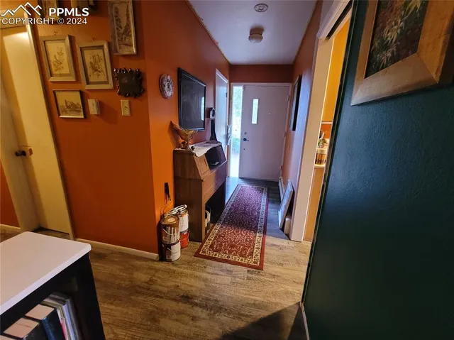 a view of a room with wooden floor and furniture