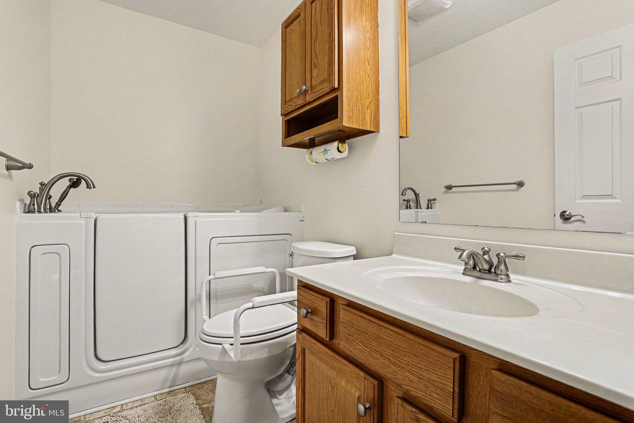 1371 Chami Drive, Unit 166 Spring Grove, PA 17362 - Photo 23 of 28 a bathroom with a sink a toilet and mirror