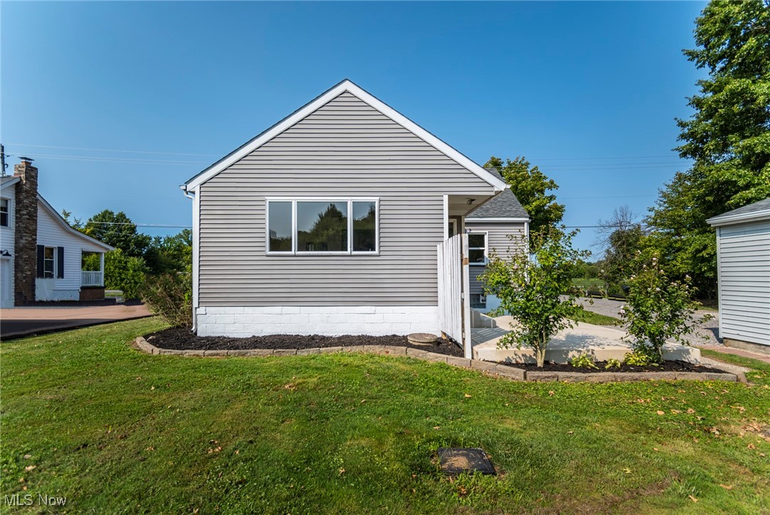 8131 Struthers Road Lowellville, OH 44436 - Photo 39 of 48 View of front facade with a patio and a front lawn