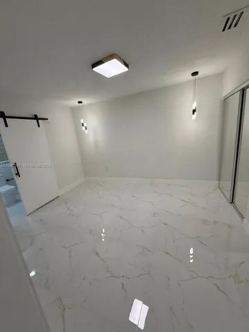 a room with a table chairs and flat screen tv