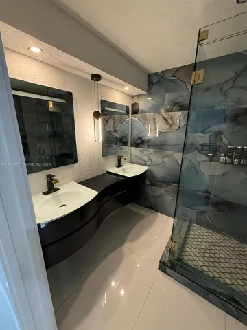 a bathroom with a sink and mirror