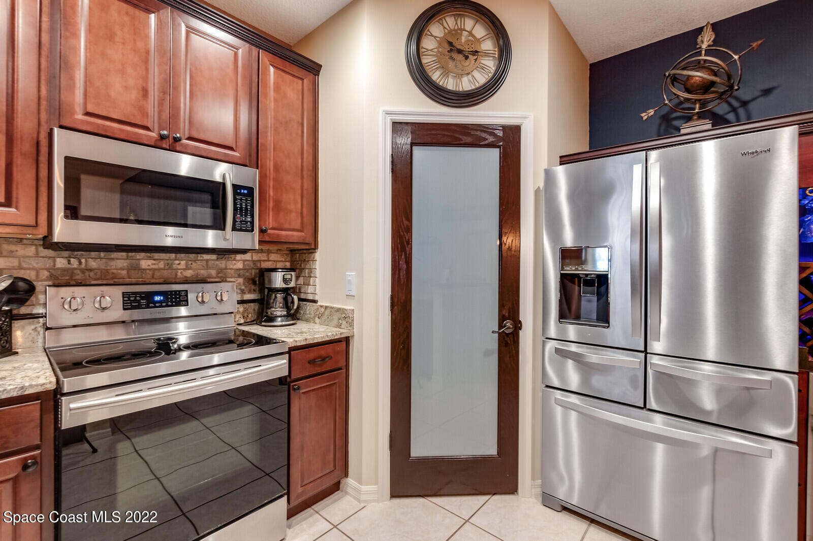 1936 Blue Ridge Avenue Melbourne, FL 32935 - Photo 14 of 35 a kitchen with stainless steel appliances granite countertop a refrigerator stove and microwave