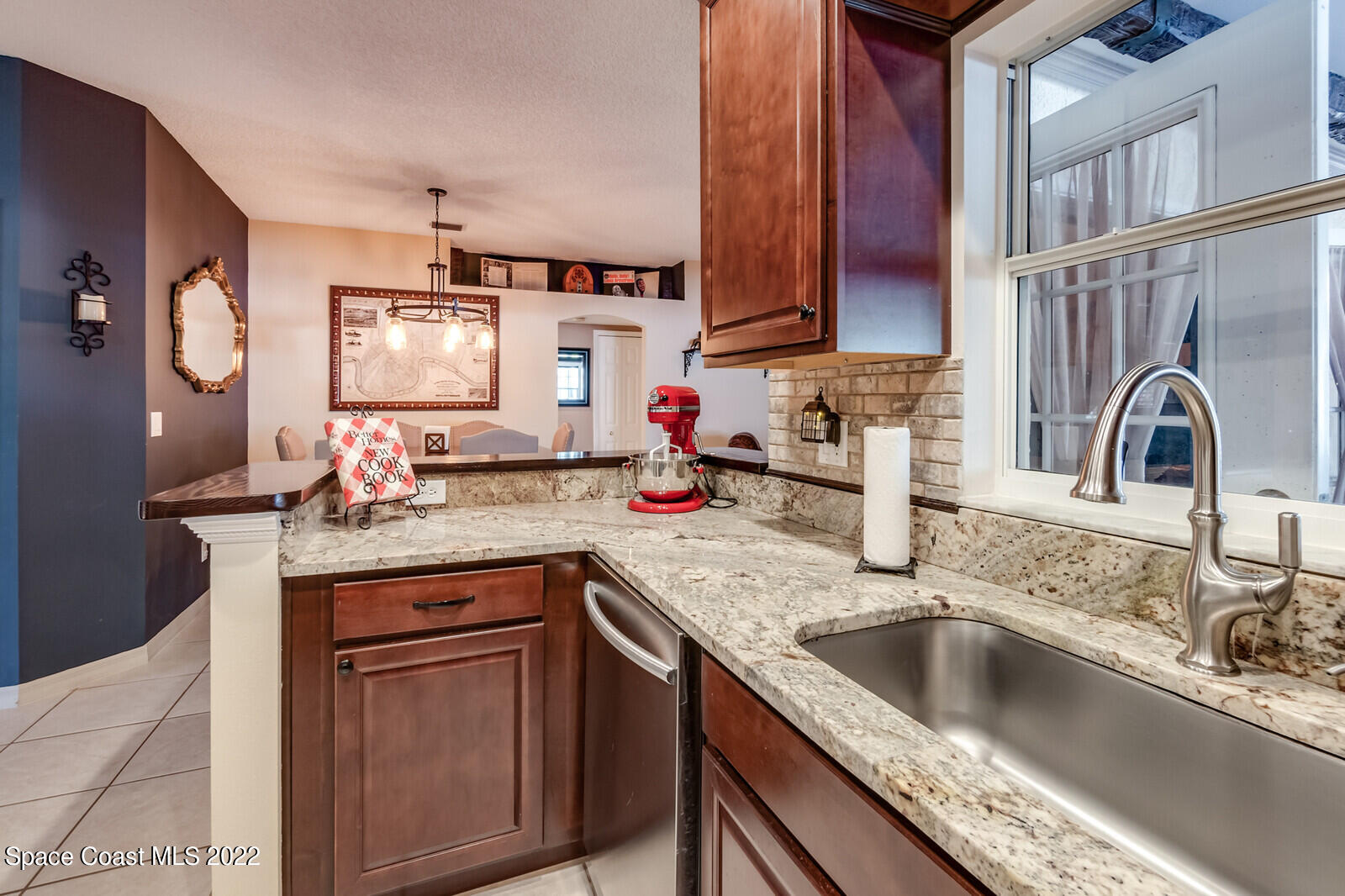 1936 Blue Ridge Avenue Melbourne, FL 32935 - Photo 15 of 35 a kitchen with granite countertop a sink and a stove