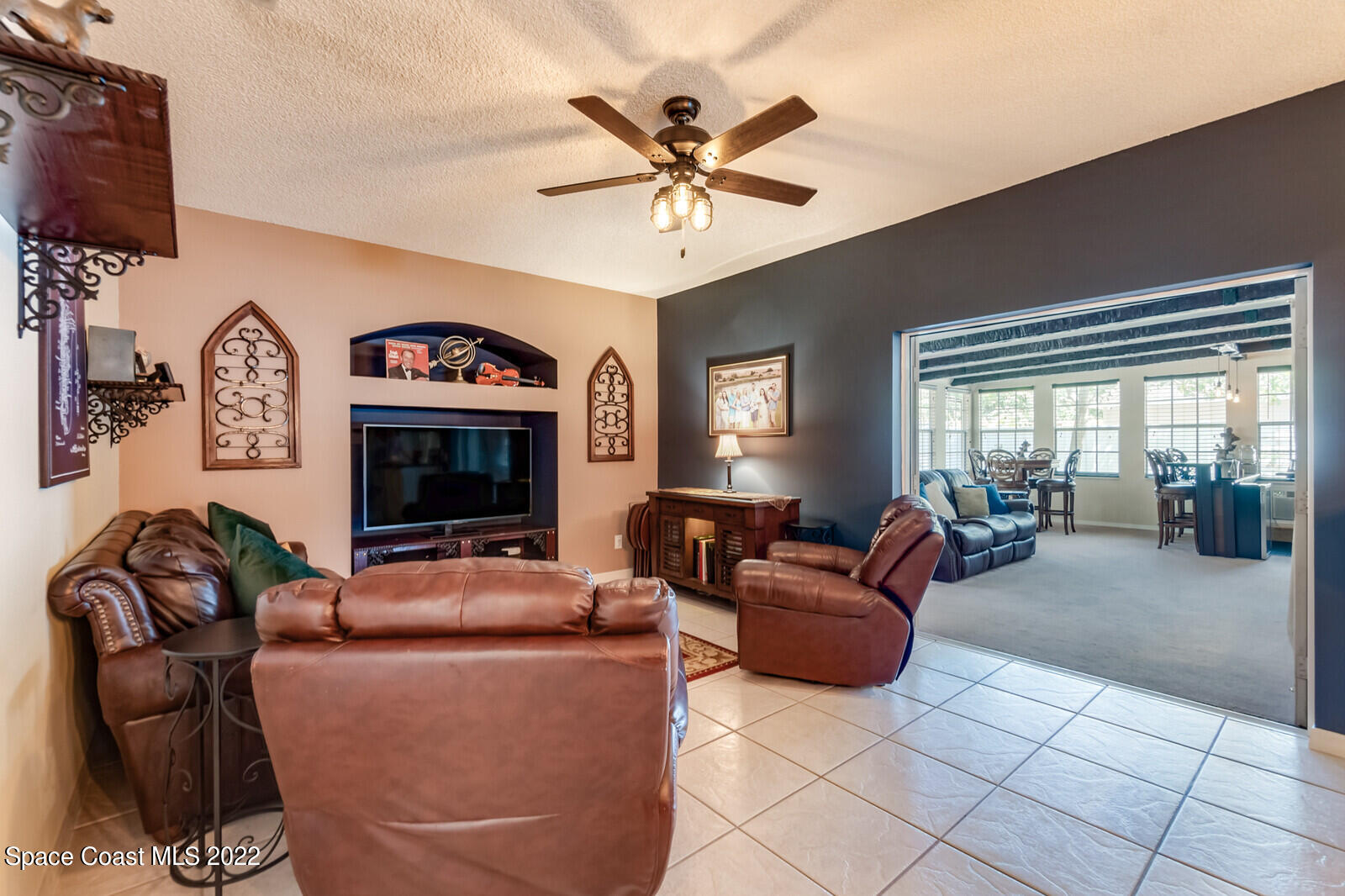 1936 Blue Ridge Avenue Melbourne, FL 32935 - Photo 20 of 35 a living room with furniture and a flat screen tv