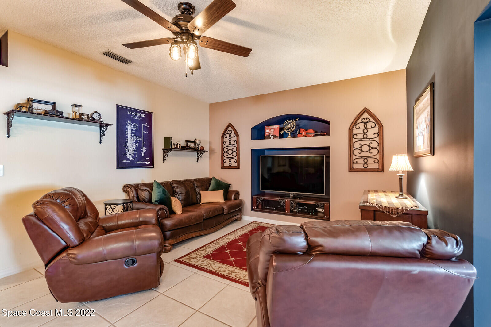 1936 Blue Ridge Avenue Melbourne, FL 32935 - Photo 21 of 35 a living room with furniture and a flat screen tv
