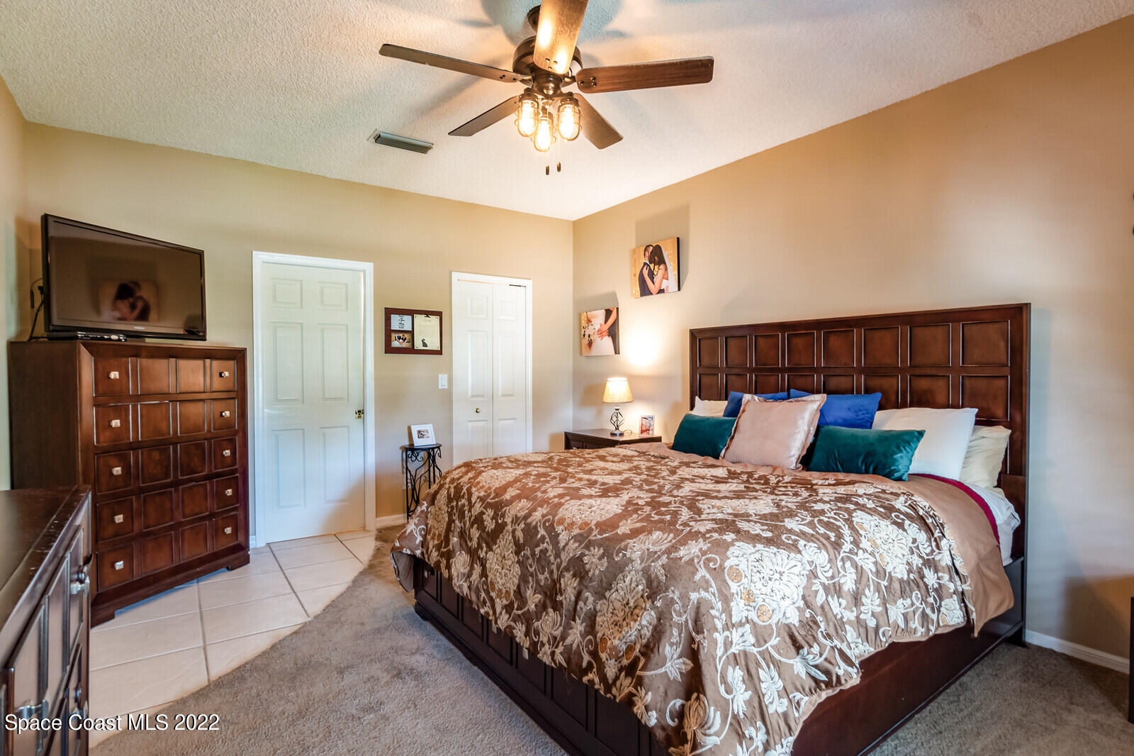 1936 Blue Ridge Avenue Melbourne, FL 32935 - Photo 27 of 35 a bedroom with a bed and a dresser