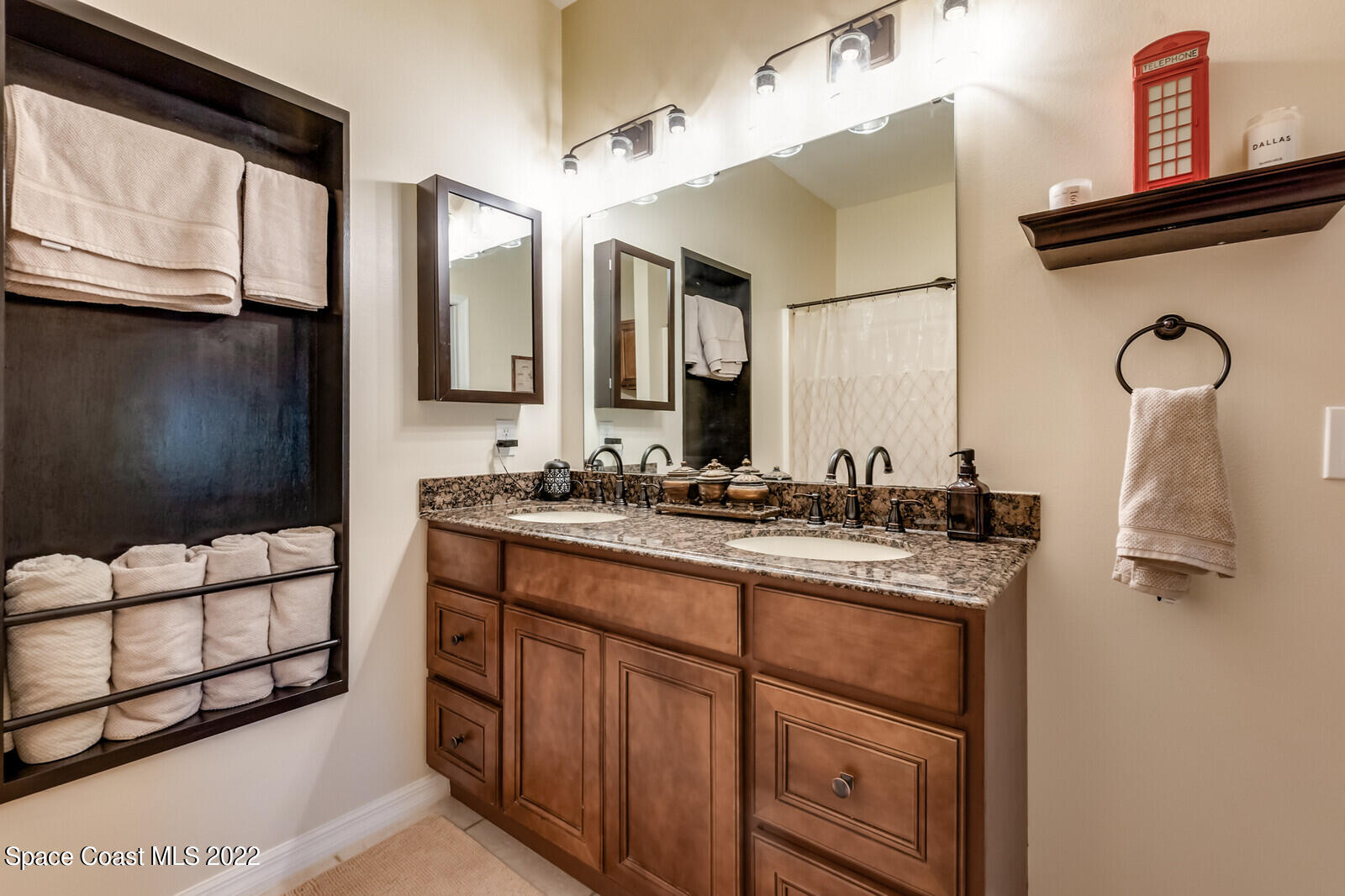 1936 Blue Ridge Avenue Melbourne, FL 32935 - Photo 29 of 35 a bathroom with a sink and a mirror