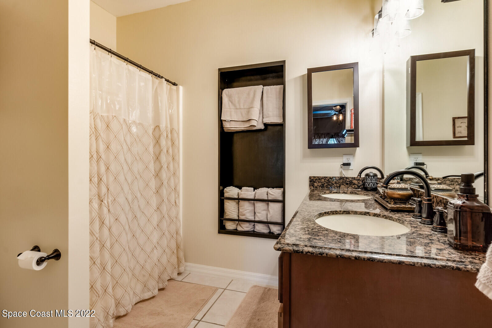 1936 Blue Ridge Avenue Melbourne, FL 32935 - Photo 30 of 35 a bathroom with a granite countertop sink and a mirror